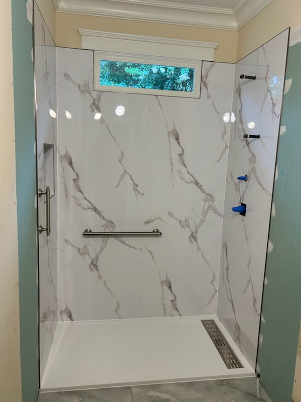 Zero-entry shower with grab bar and linear drain by Shower Pans LLC