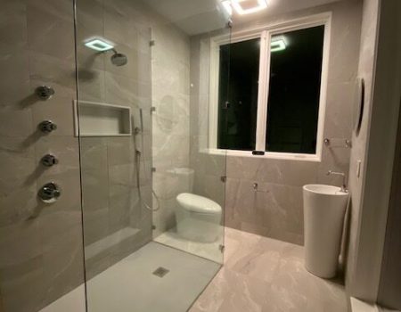A bathroom with a large walk in shower.
